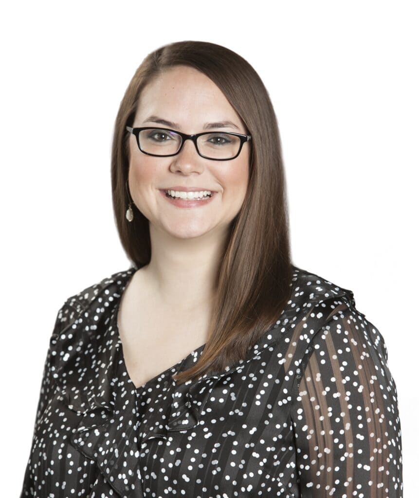 Professional portrait of Mary Hendrix with glasses and a polka dot blouse.