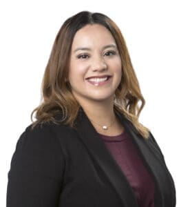 Tisha Guzman smiling in professional attire for business profile.