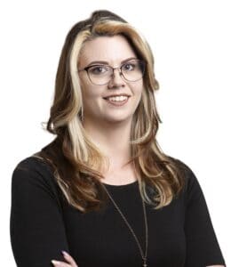 Portrait of Cait Miller with glasses and blonde hair for Corridor Title.
