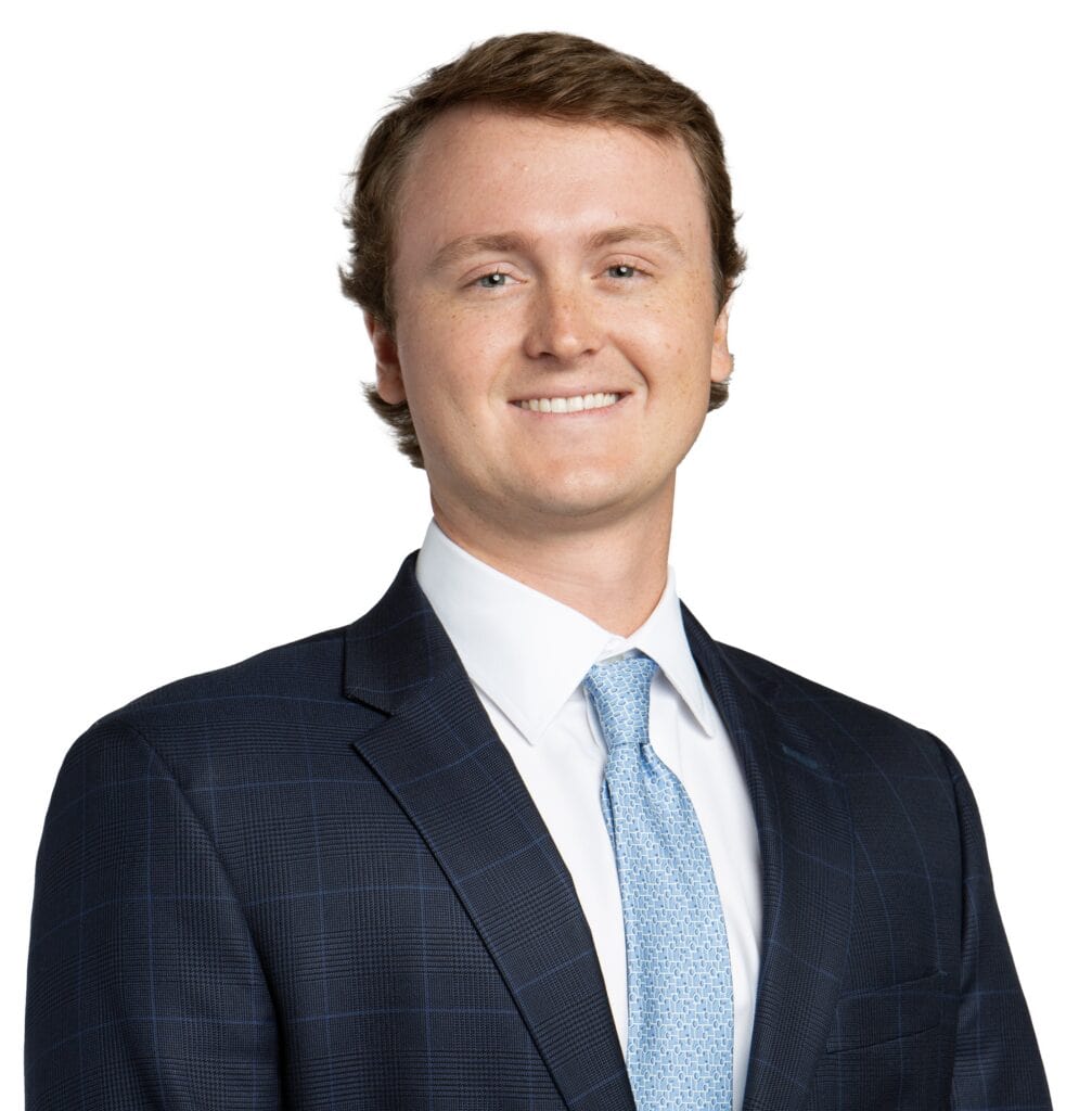 Cullen Lowder wearing a suit and tie, smiling for the camera.