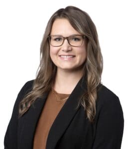 Sarah Marshall in professional attire with glasses for business profile.