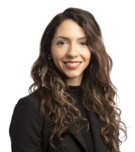 Portrait of Valerie Kilcrease with long wavy hair and a black blazer.