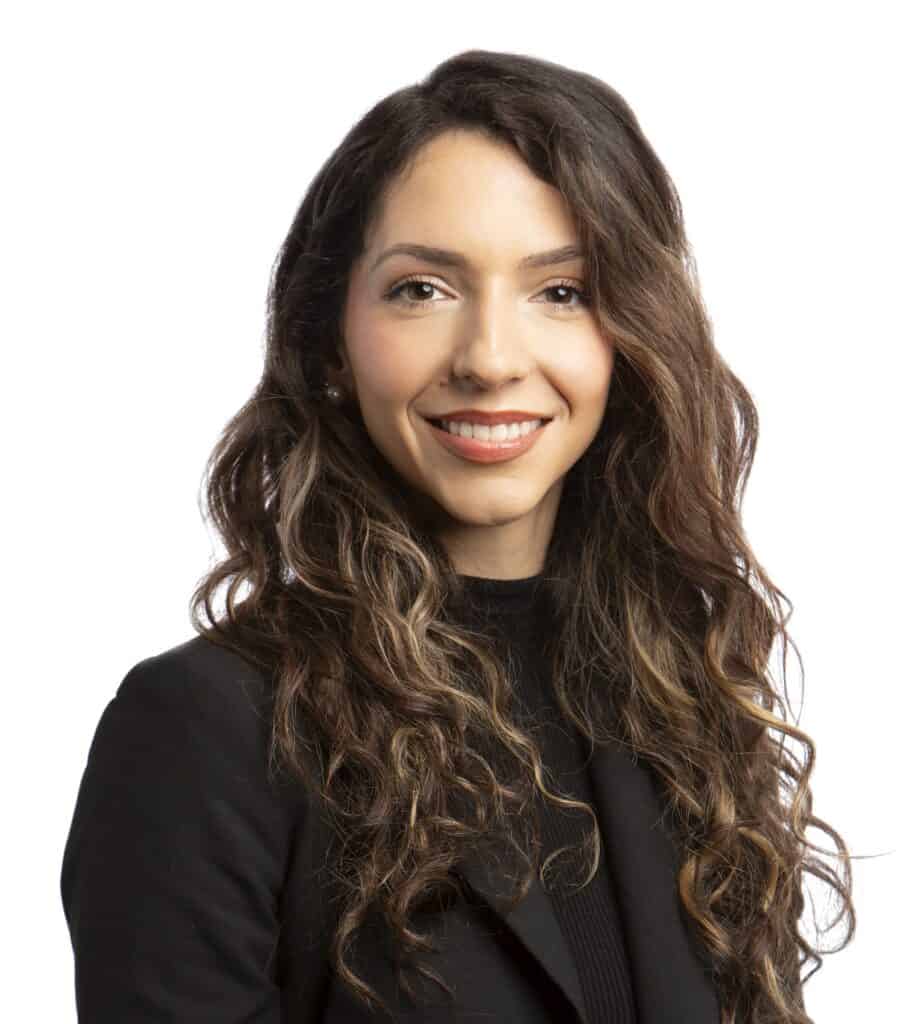 Portrait of Valerie Kilcrease with long wavy hair and a black blazer.