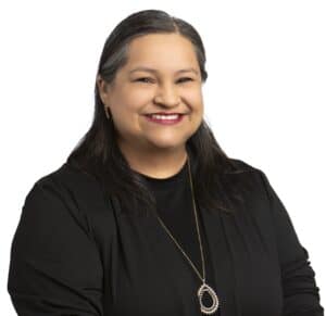Anna Ramirez smiling in a professional portrait for Corridor Title.